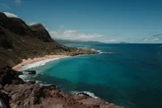 Turquoise water filling a rocky cove.