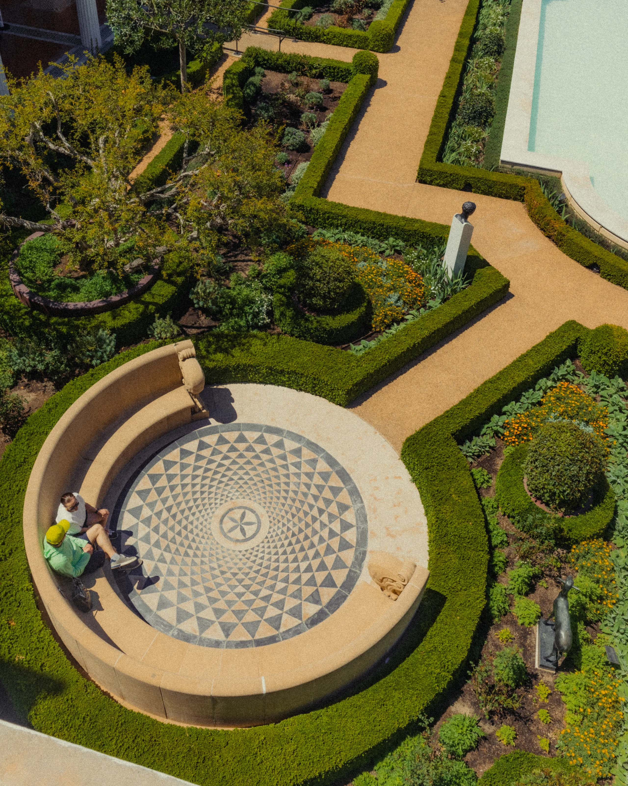 Geometric Getty Villa garden with clipped hedges and circular mosaic seating