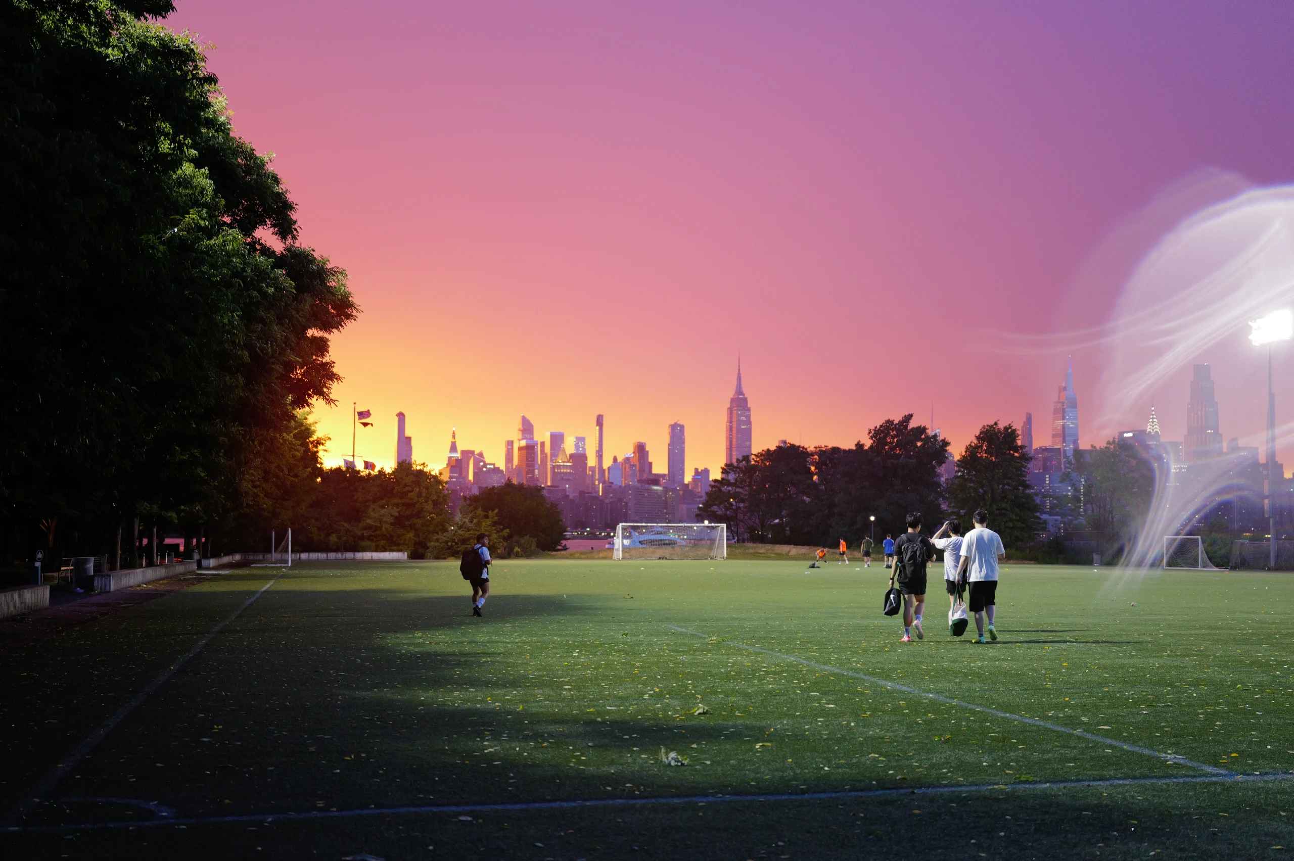 Soccer players walking across a waterfront field with Manhattan glowing under a vivid magenta sunset.