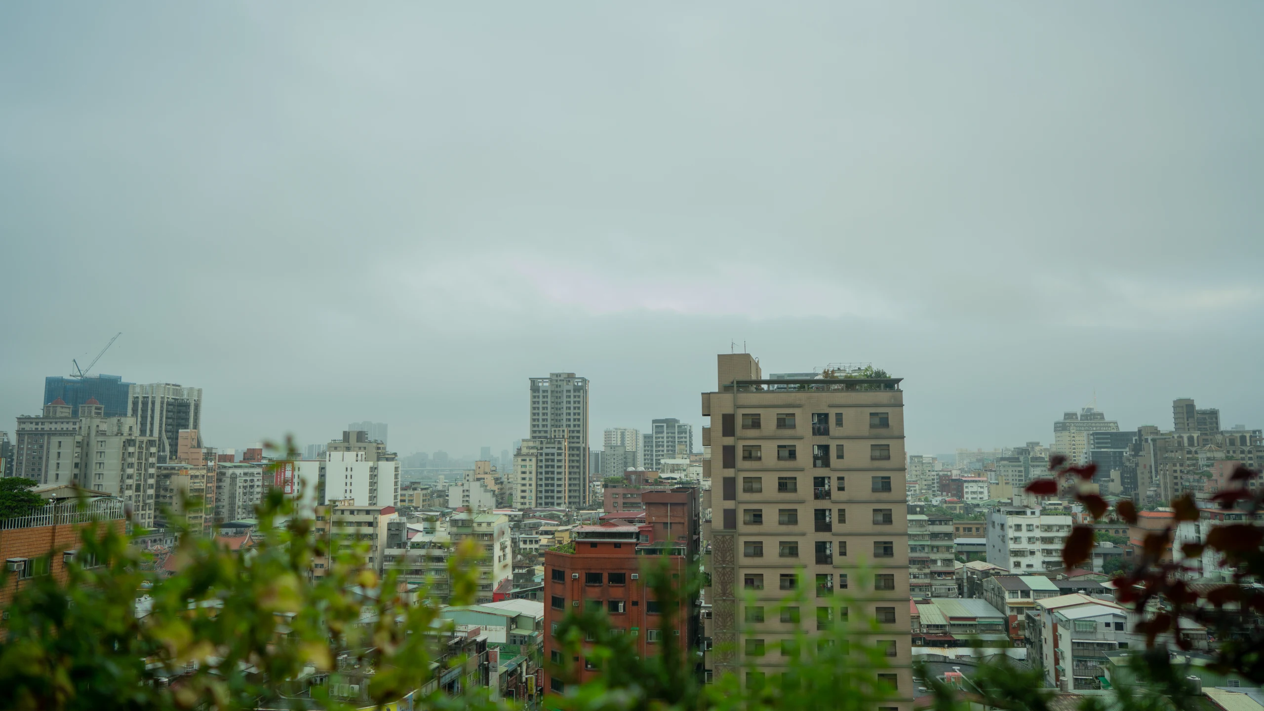 Taipei skyline beneath an overcast sky.