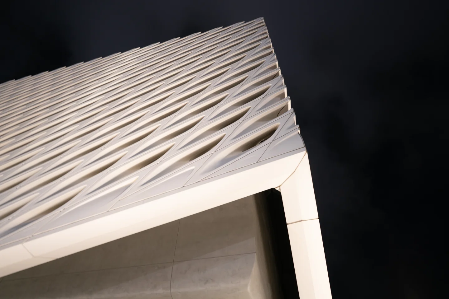 White modern architecture viewed from below against the sky.