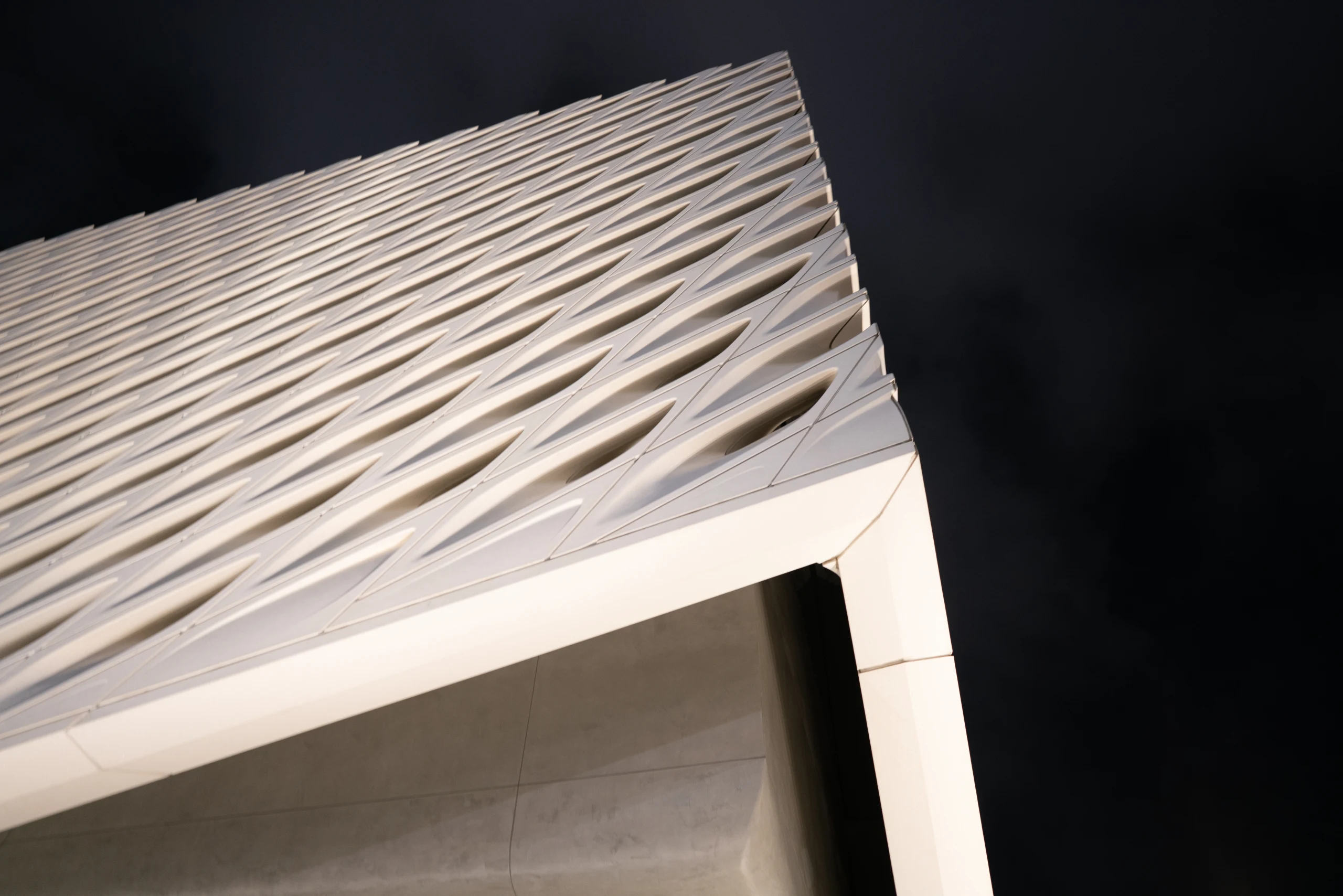 White modern architecture viewed from below against the sky.