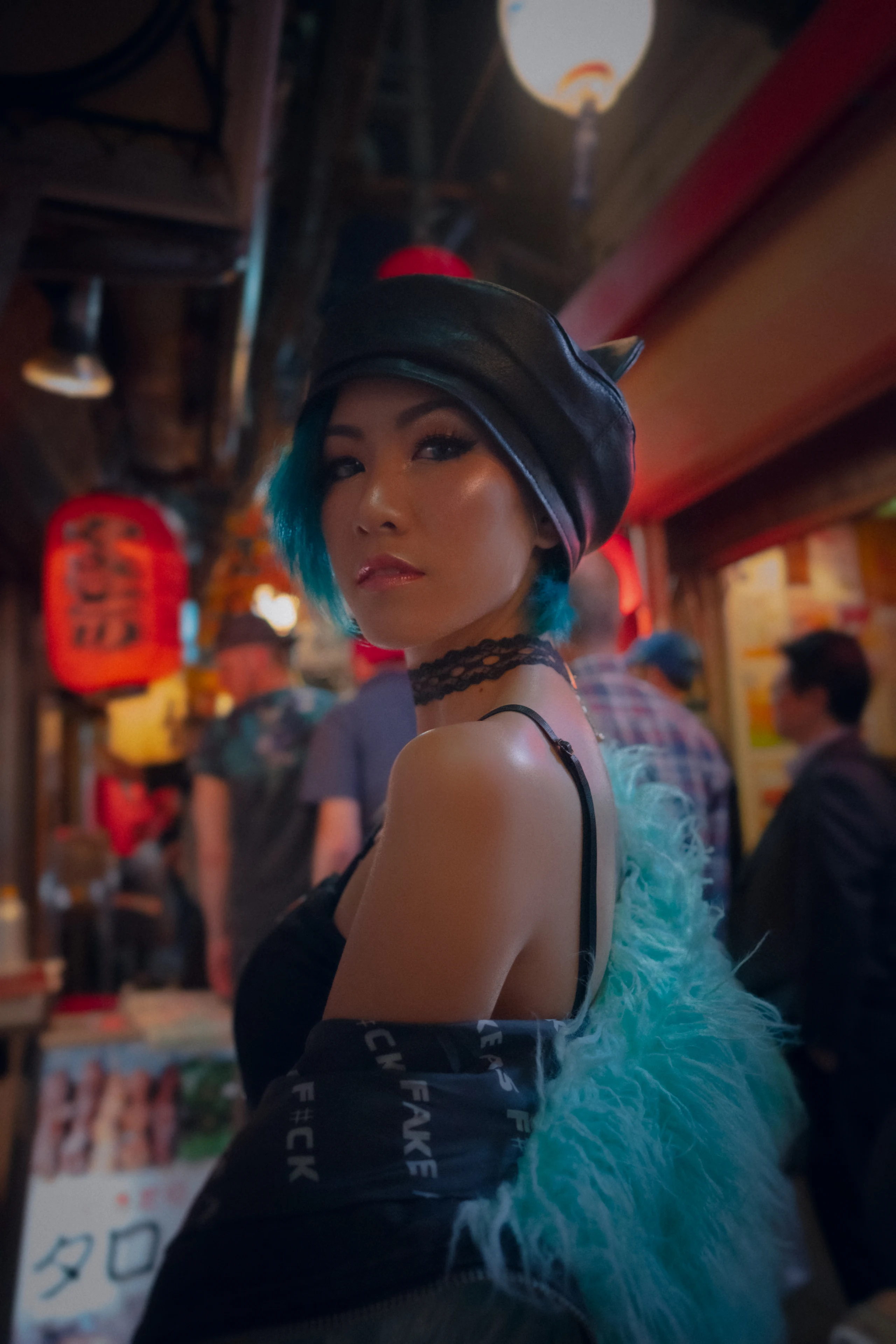 A woman in a pale feathered wrap looks back in a neon-lit restaurant alley.