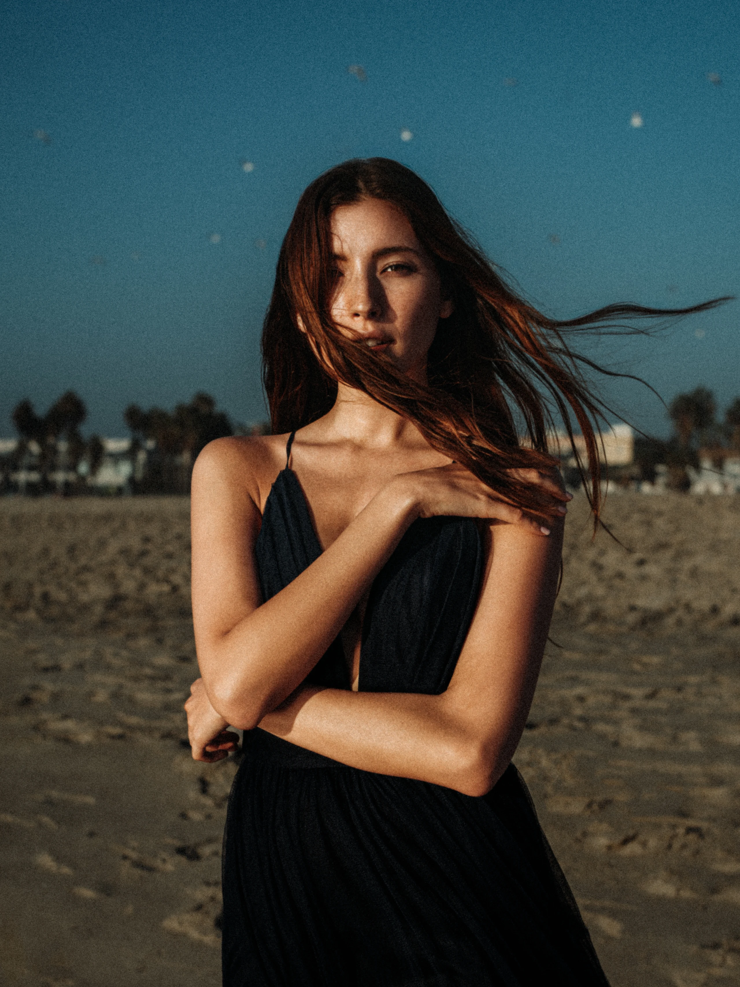 Close portrait of a woman on a windy beach.