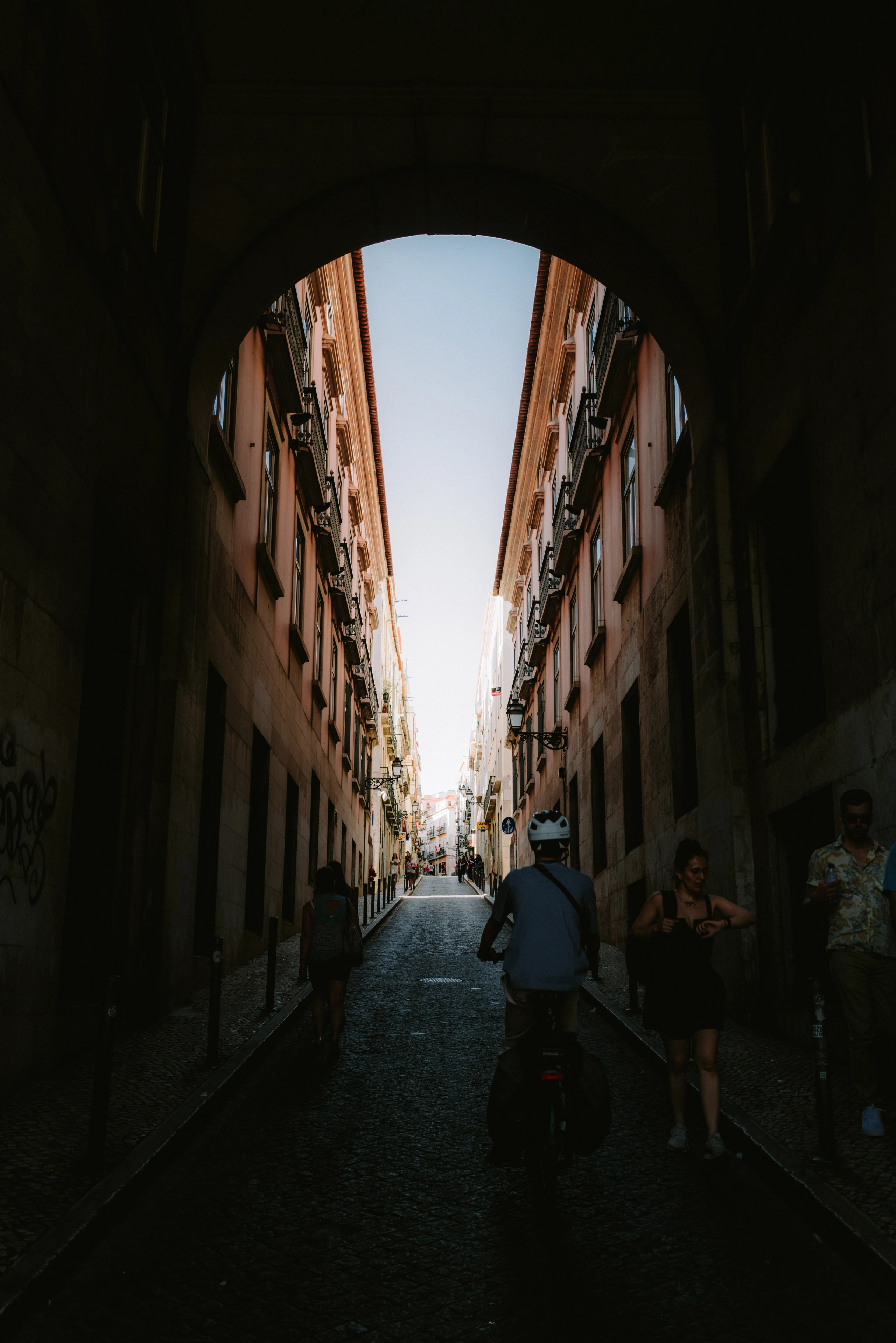 A deep shadow frames a bright narrow street.
