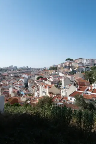 Lisbon rooftops spread across a sunlit hillside.