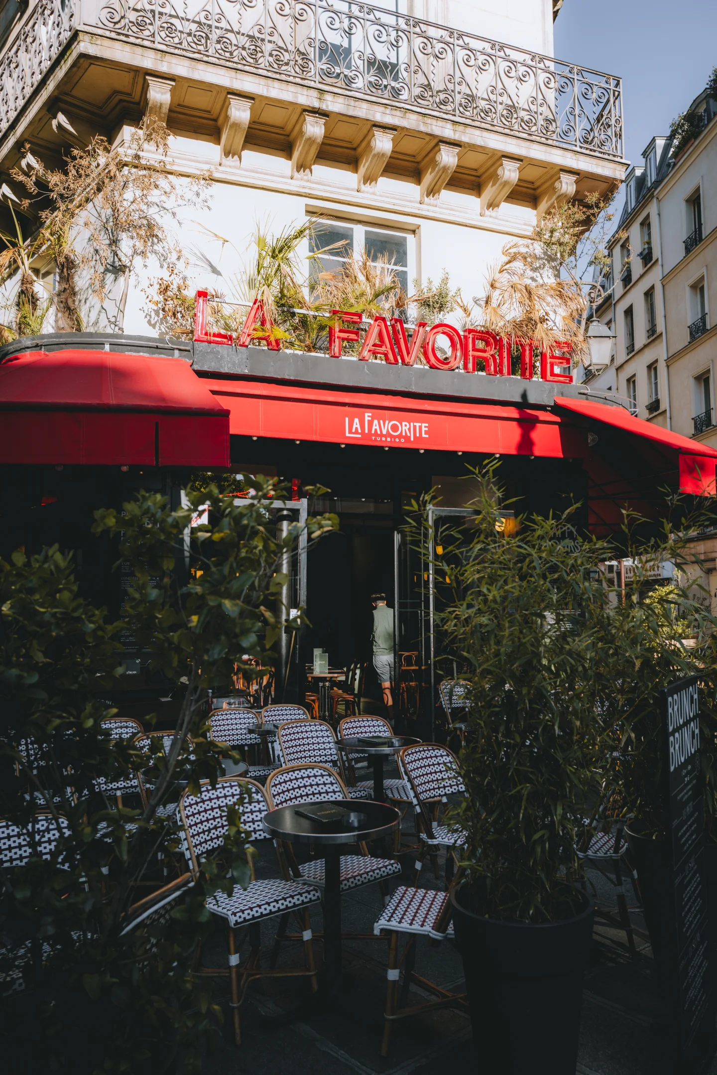 Red café exterior along a Paris street.