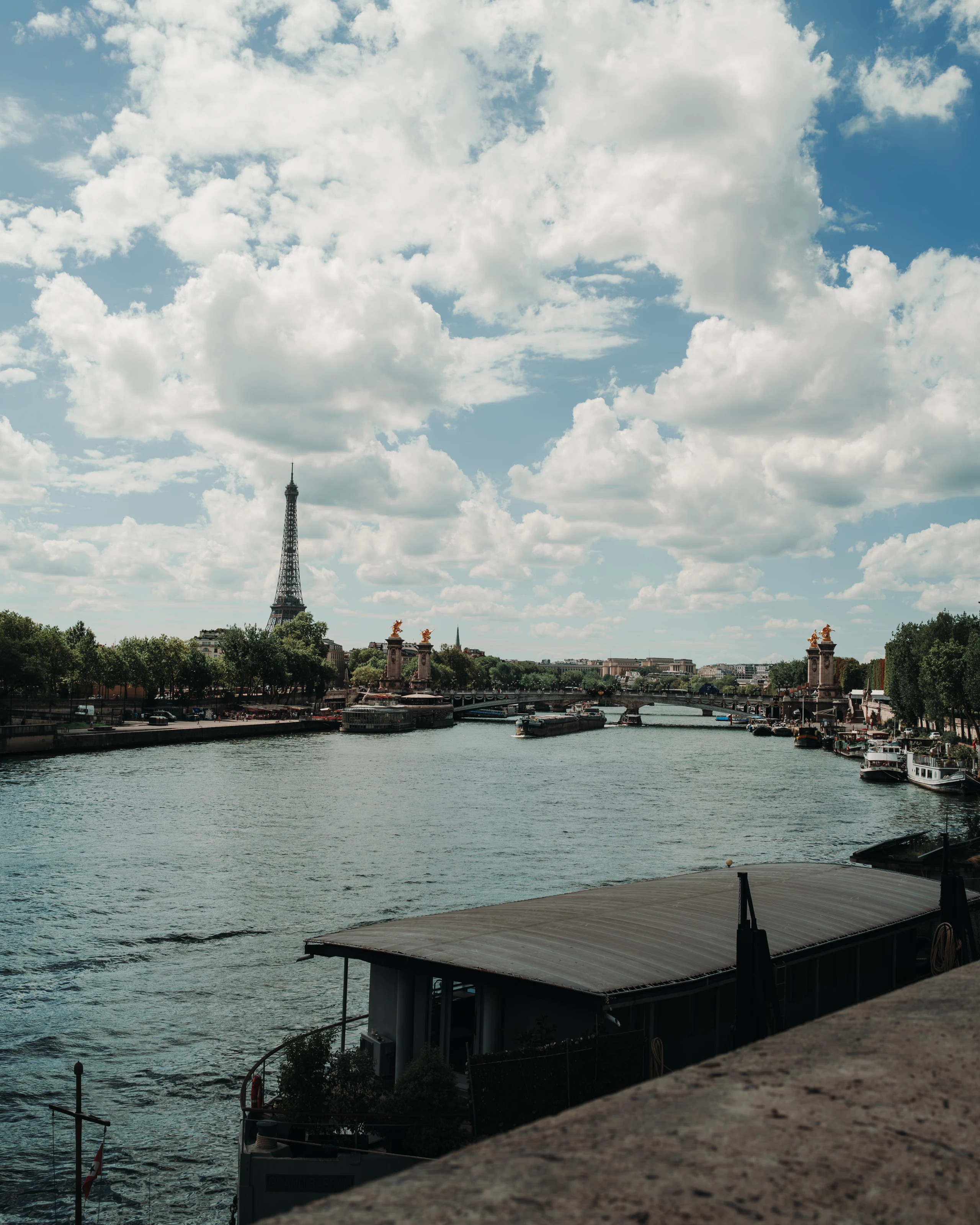 The Seine viewed from a stone embankment.